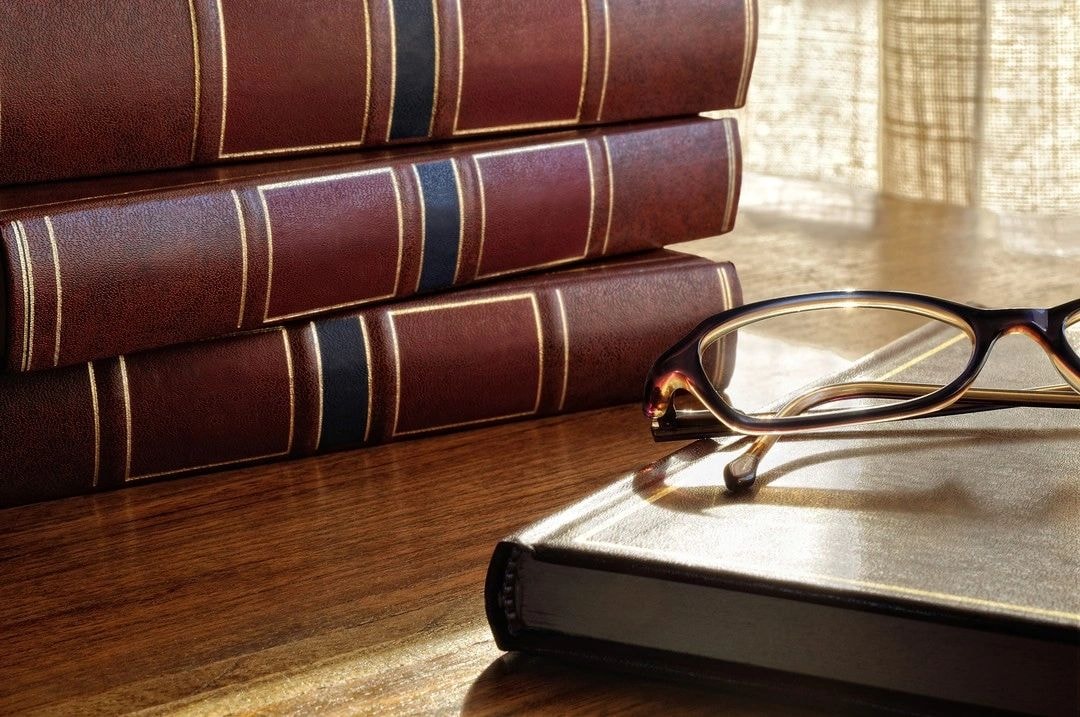 Leather-bound law books and eyeglasses